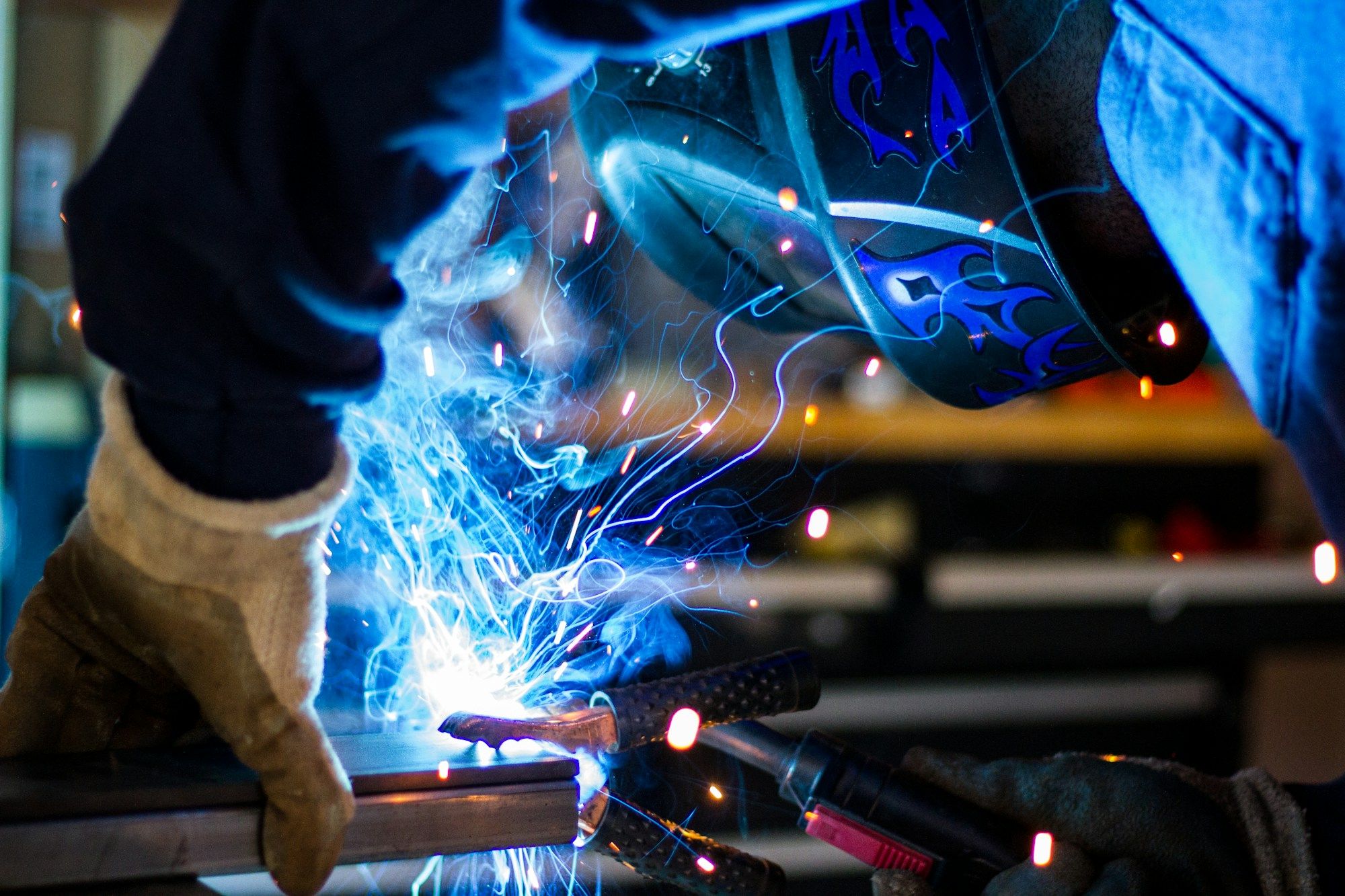 Welder working on a metal assembly
